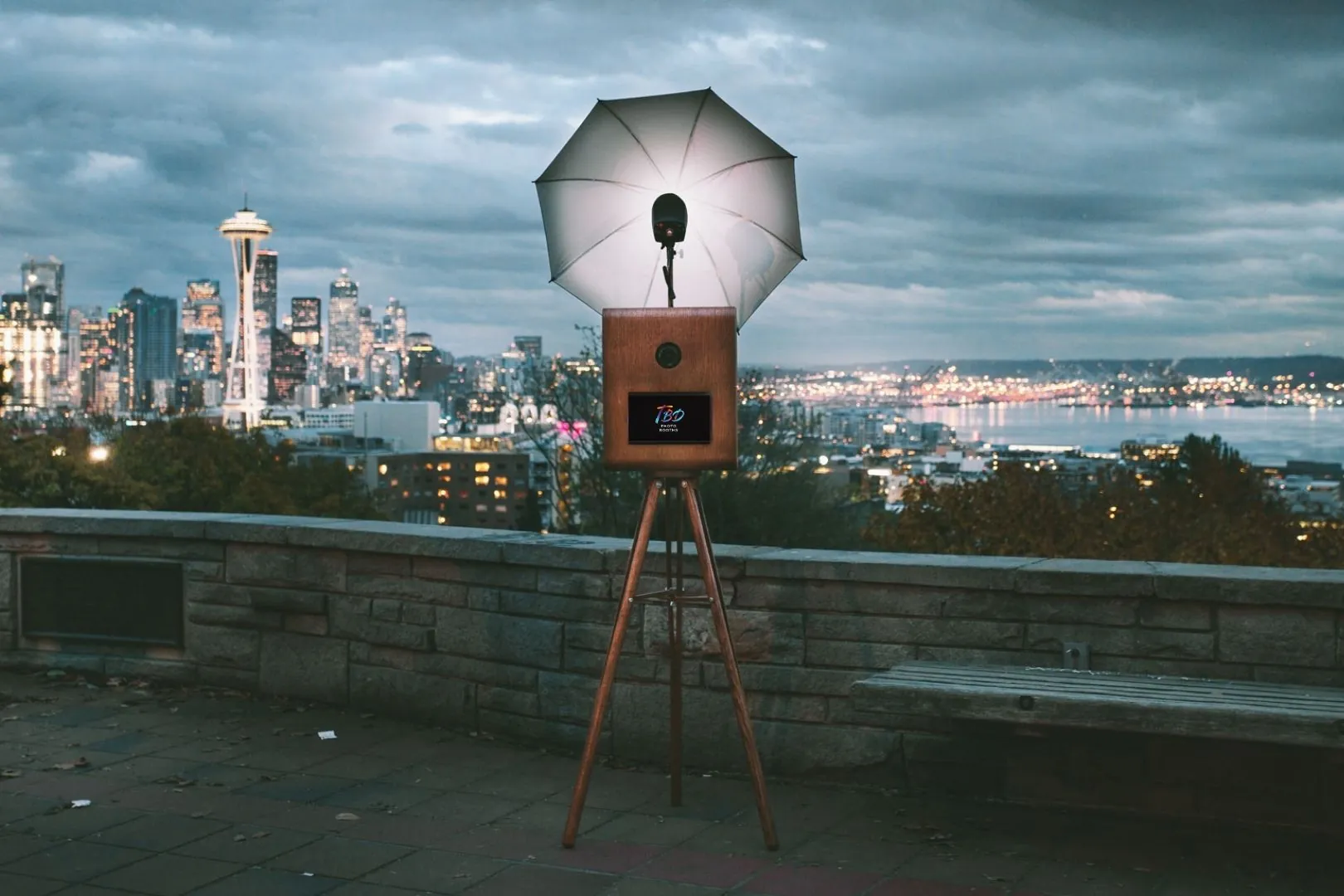The walnut photo booth set up outdoors with a view of the Seattle skyline