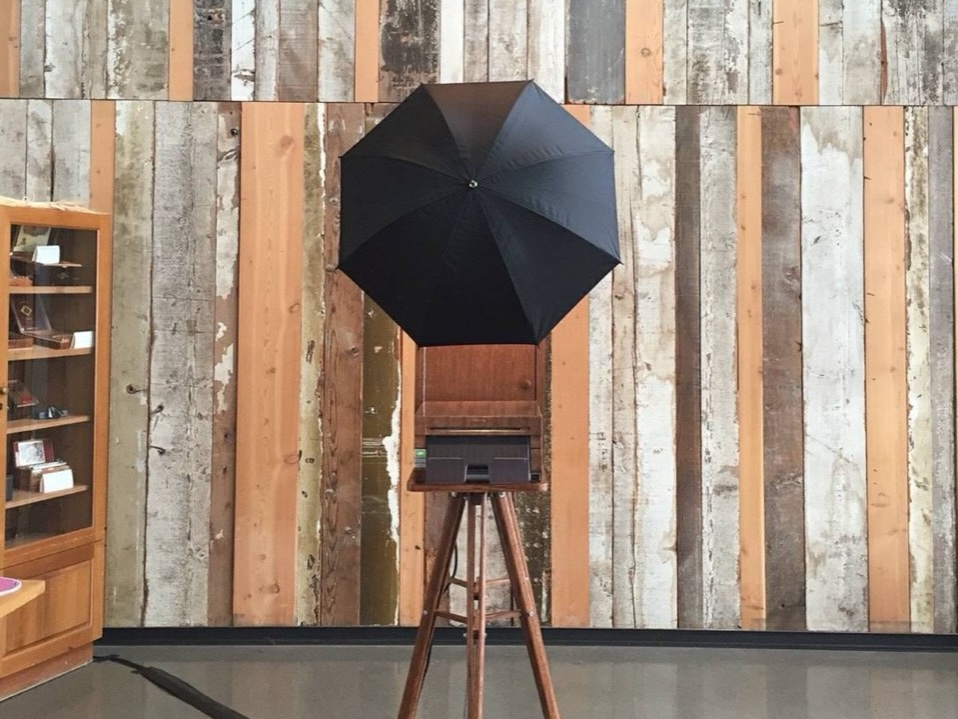 The walnut booth against a reclaimed wood wall at an event